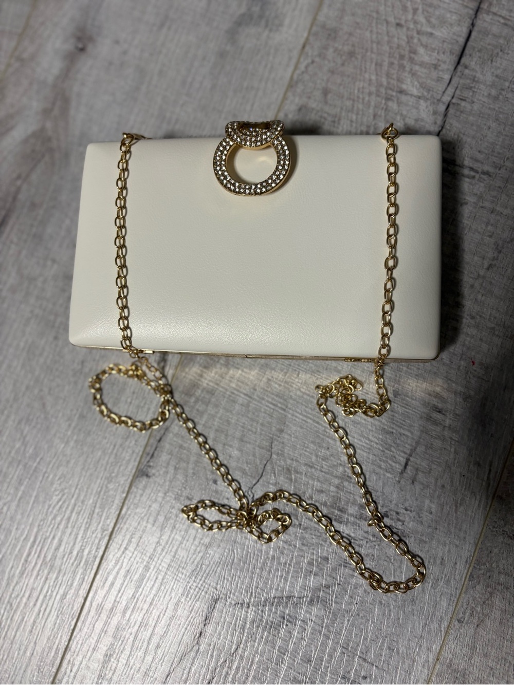 Elegant White Clutch with Gold Chain and Crystal Accent